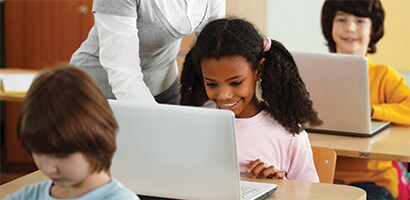 Kids in a classroom on laptop computers
